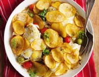 Baked fish with scallop potatoes, tomatoes and olives