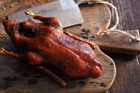 Crisp-skinned szechuan duck with lotus root and edamame stir-fry