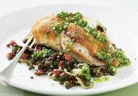 Pan-fried chicken on lentils with pesto